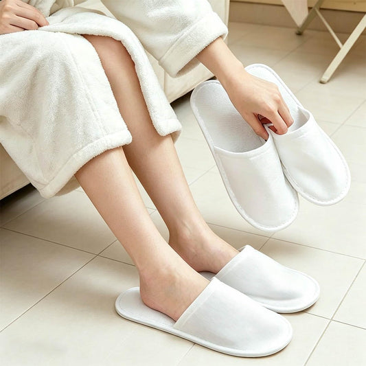 COTELEEC individually sealed pair opened to reveal clean disposable slippers for hygiene