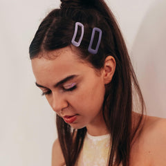 Cptots clip holding bangs in place demonstrating secure, gentle hold