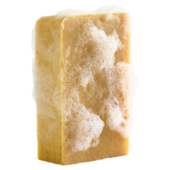 Crate 61 Organics lifestyle bath scene with bar beside towel showing calming bathroom styling benefit