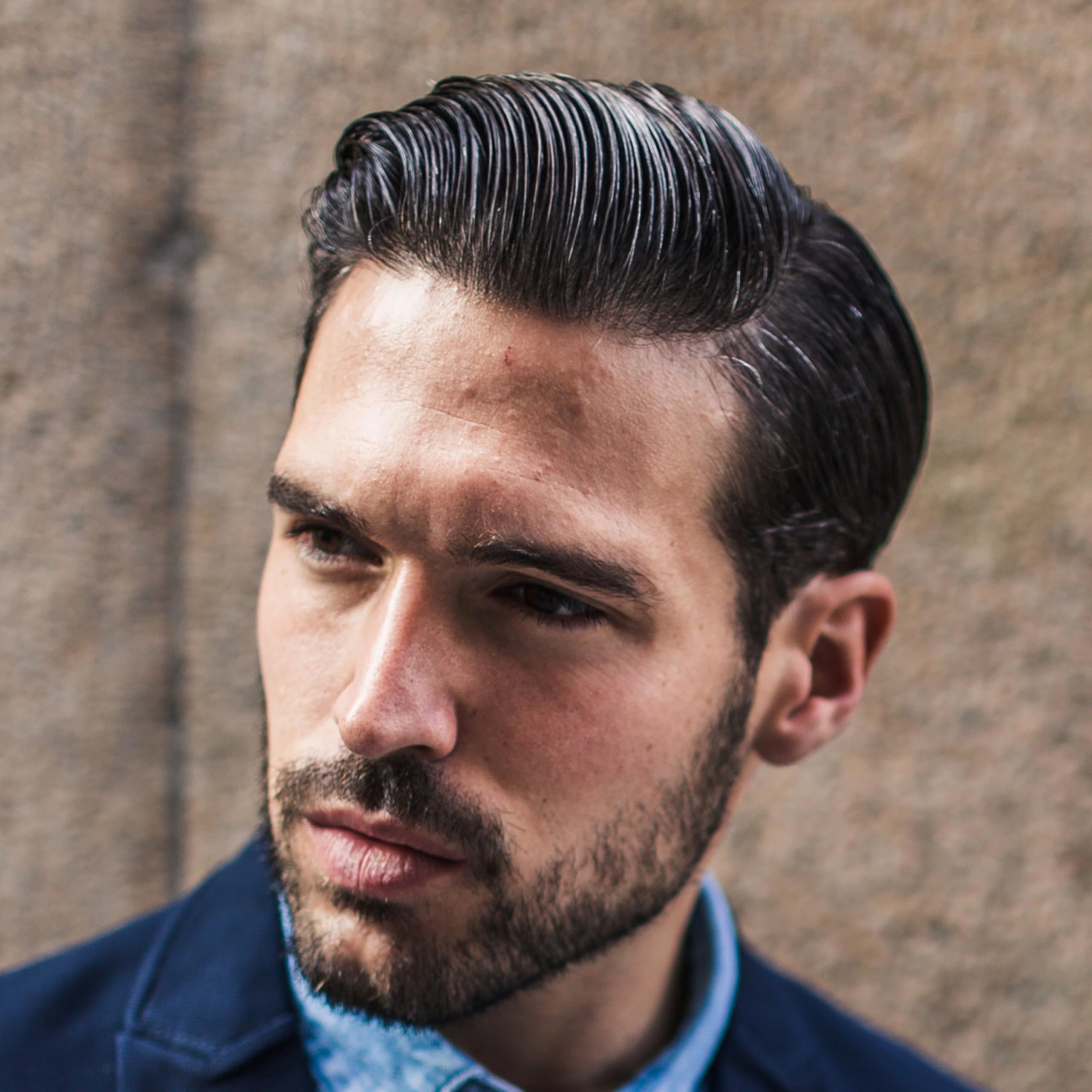 Cremo pomade on hands demonstrating easy workability and spreadability