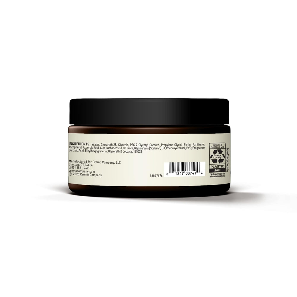 Cremo pomade next to coin displaying 3.4 oz size for travel convenience