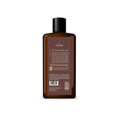 Cremo bottle in hand size comparison showing 16 fl oz scale and travel-friendly benefit