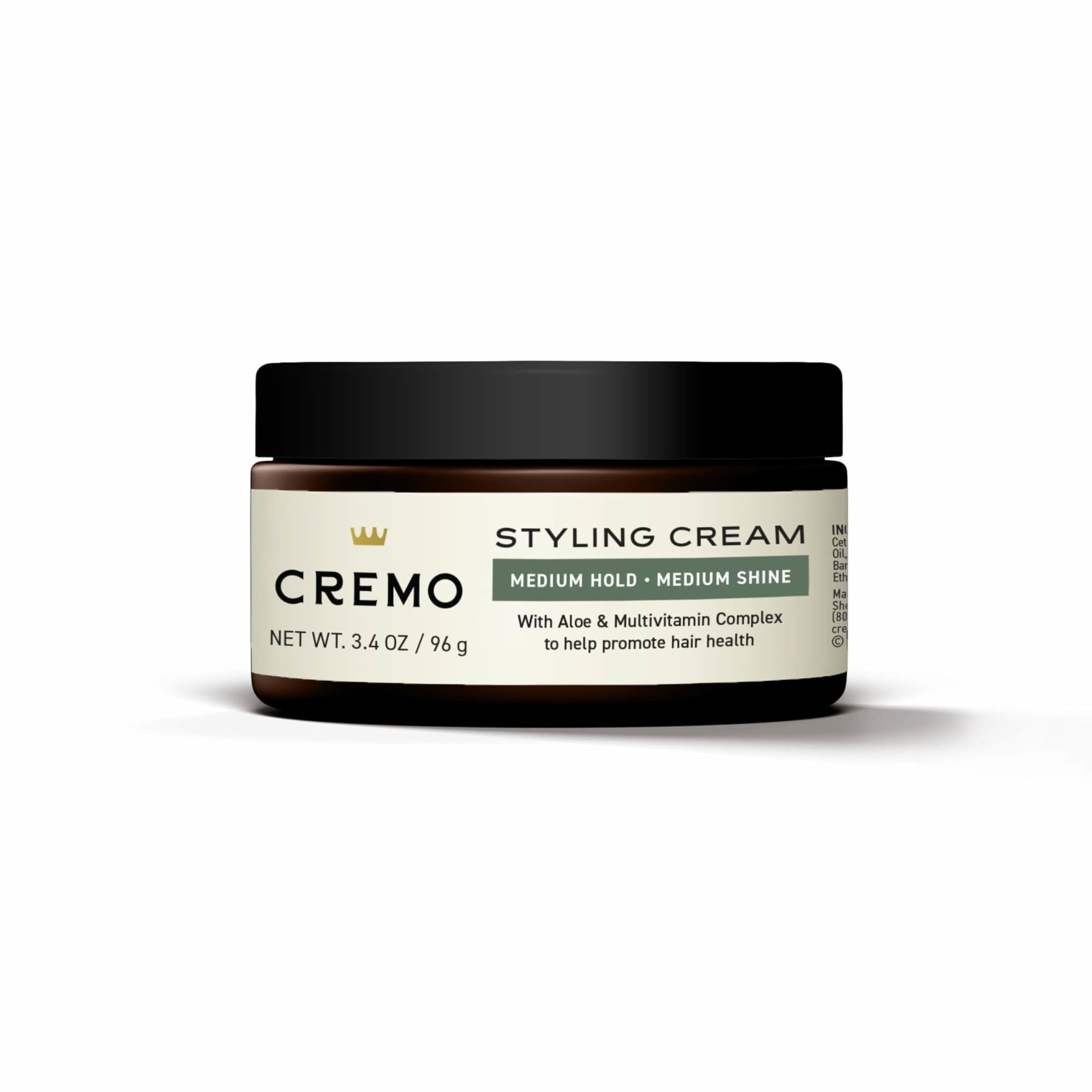 Cremo beside travel toiletries illustrating compact 3.4 oz size for trips