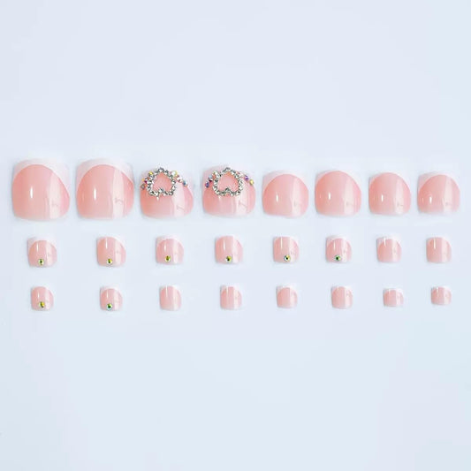 CTTHNBD close-up of tiny heart accent on a French tip nail highlighting delicate decorative detail