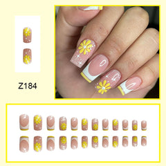 CTTHNBD close-up of French tip with yellow flower for precise design detail and chic look