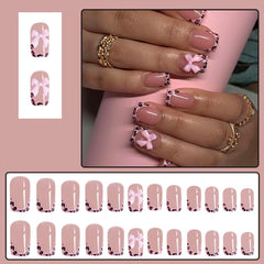 CTTHNBD arranged nail set top view displaying leopard French tips and glossy bow for inspiration