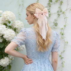 Cupeou bow worn in ponytail demonstrating styling versatility and polish