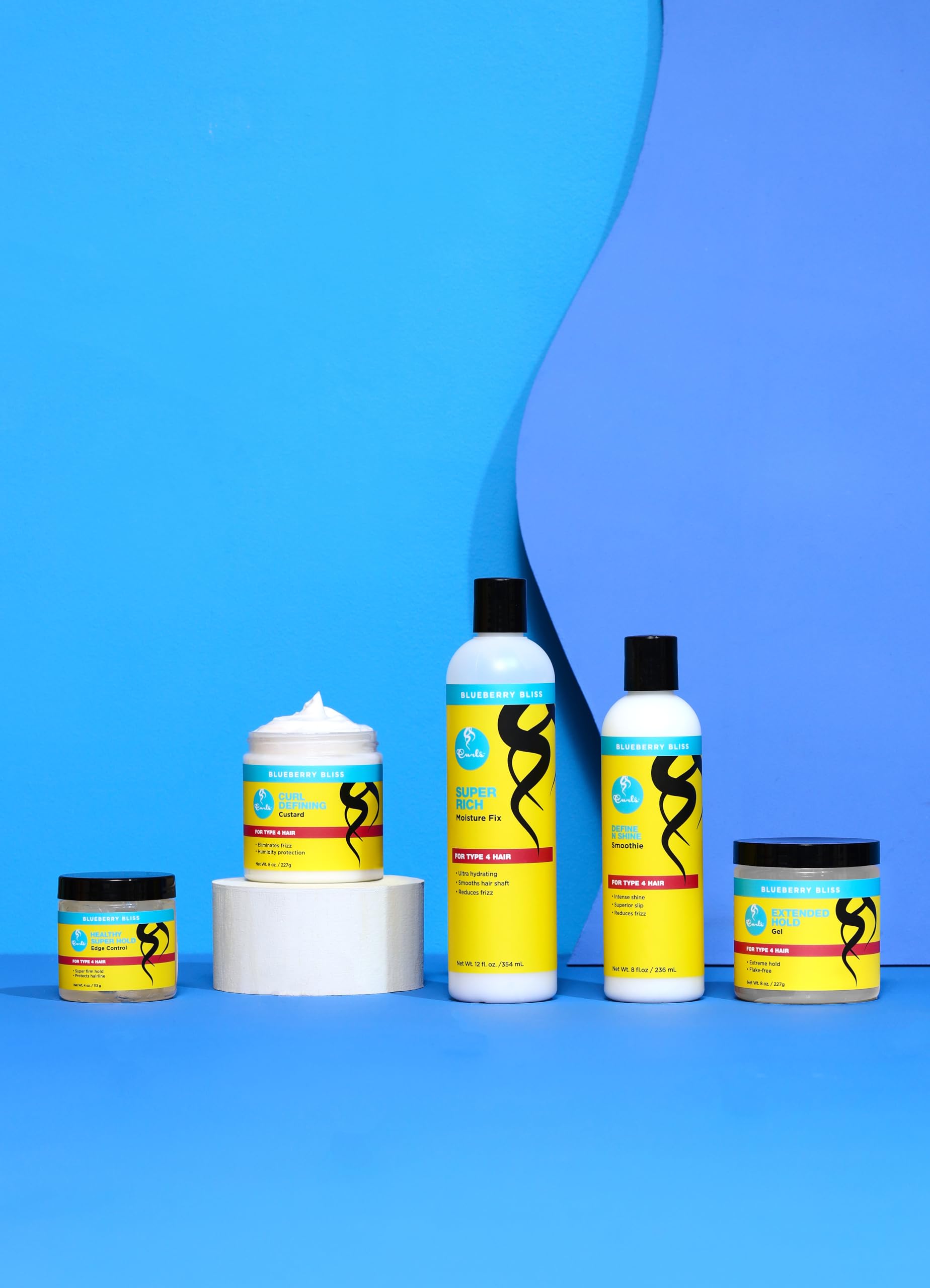 Curls Blueberry Bliss used to smooth edges on a sleek ponytail demonstrating long-lasting shine