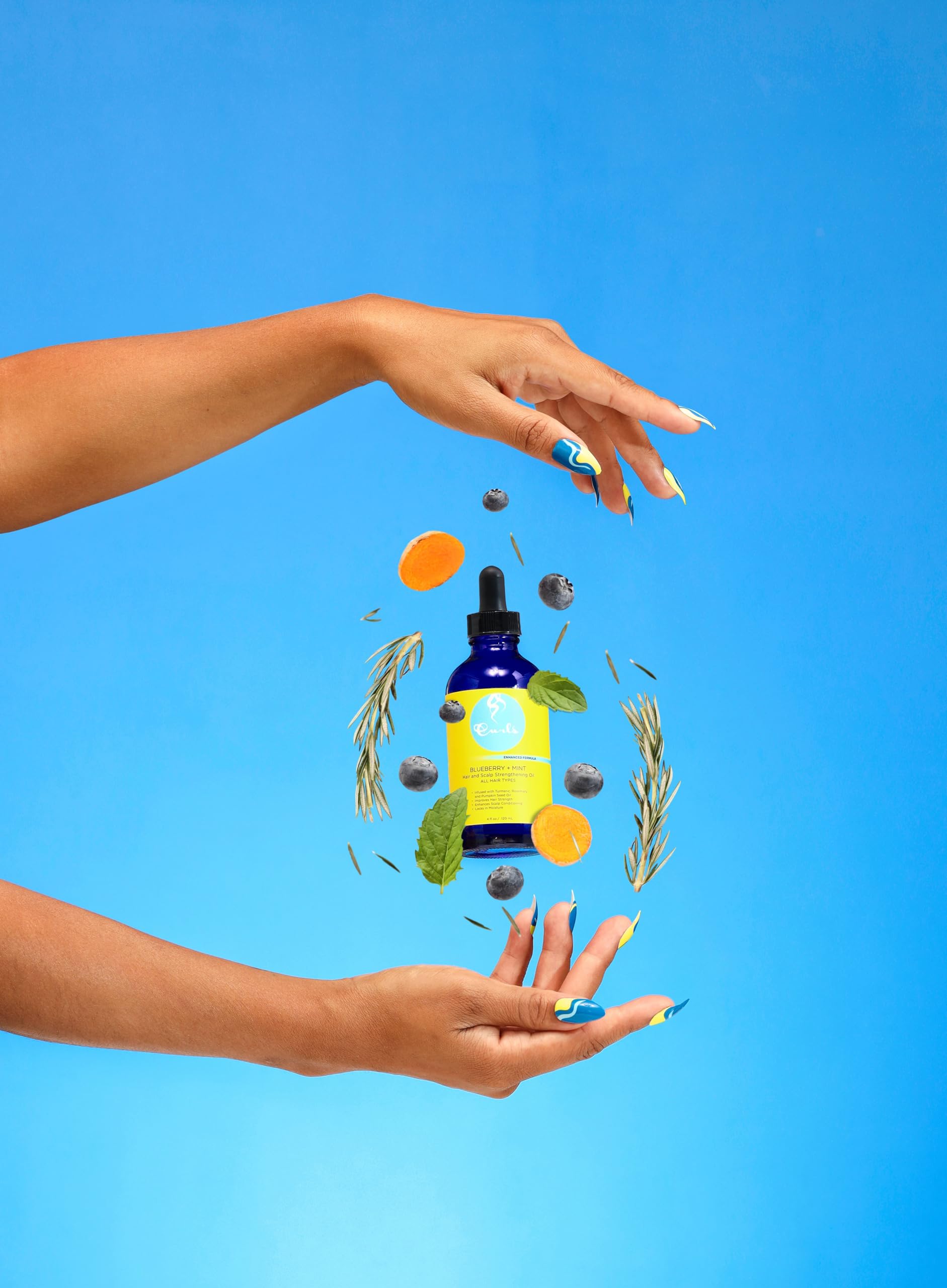 Curls Blueberry Bliss smoothed on hair ends showing protective shine