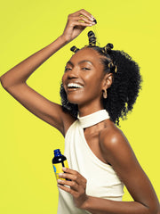 Curls Blueberry Bliss bottle staged on a bathroom shelf with fresh berries showing daily use