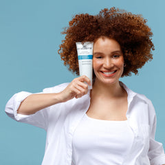 CURLSMITH 2 oz jar in hand showing travel-friendly size and convenience