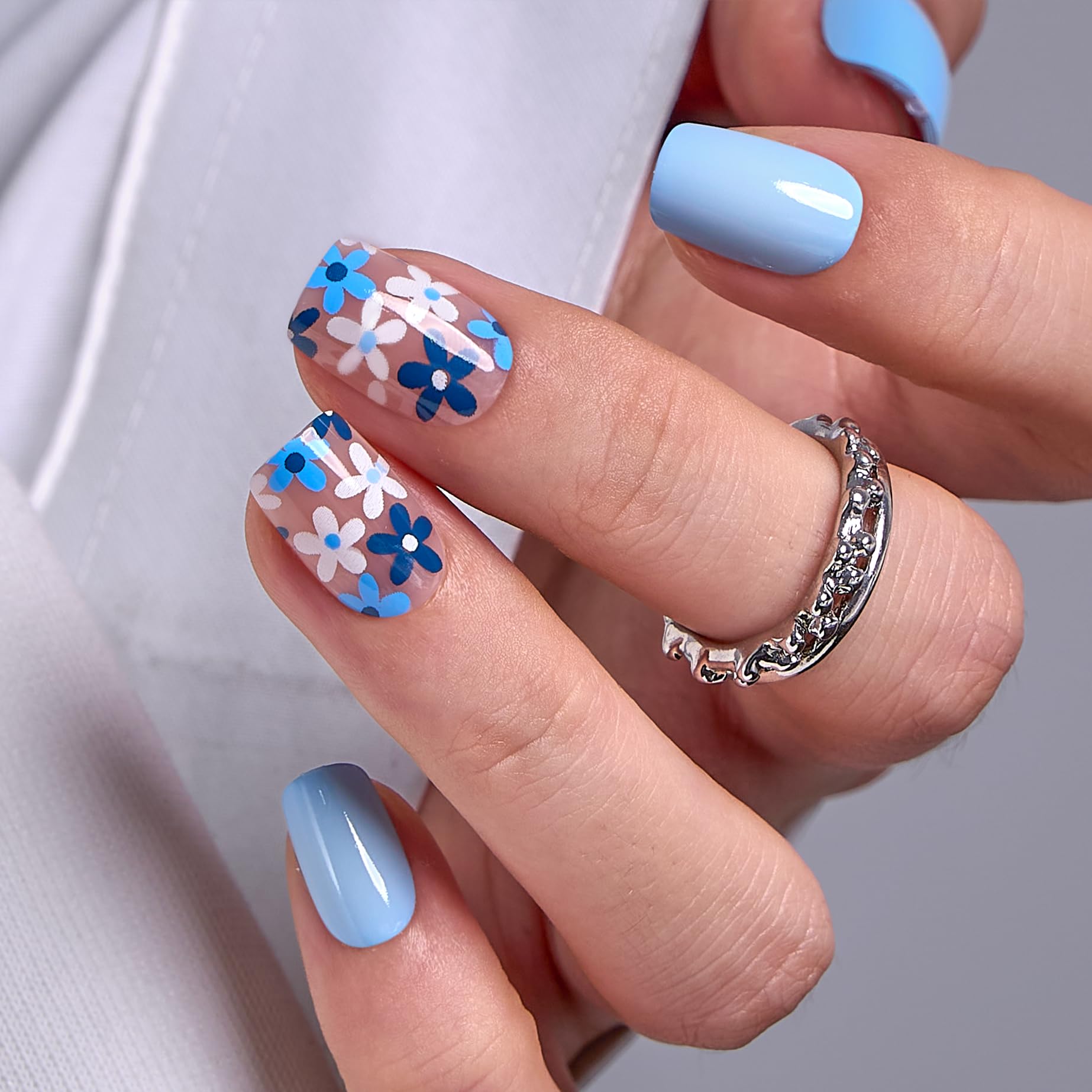 Curvlife front packaging showing azure blue floral press-on nails and box benefits