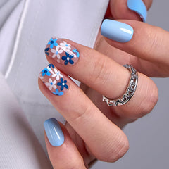 Curvlife front packaging showing azure blue floral press-on nails and box benefits