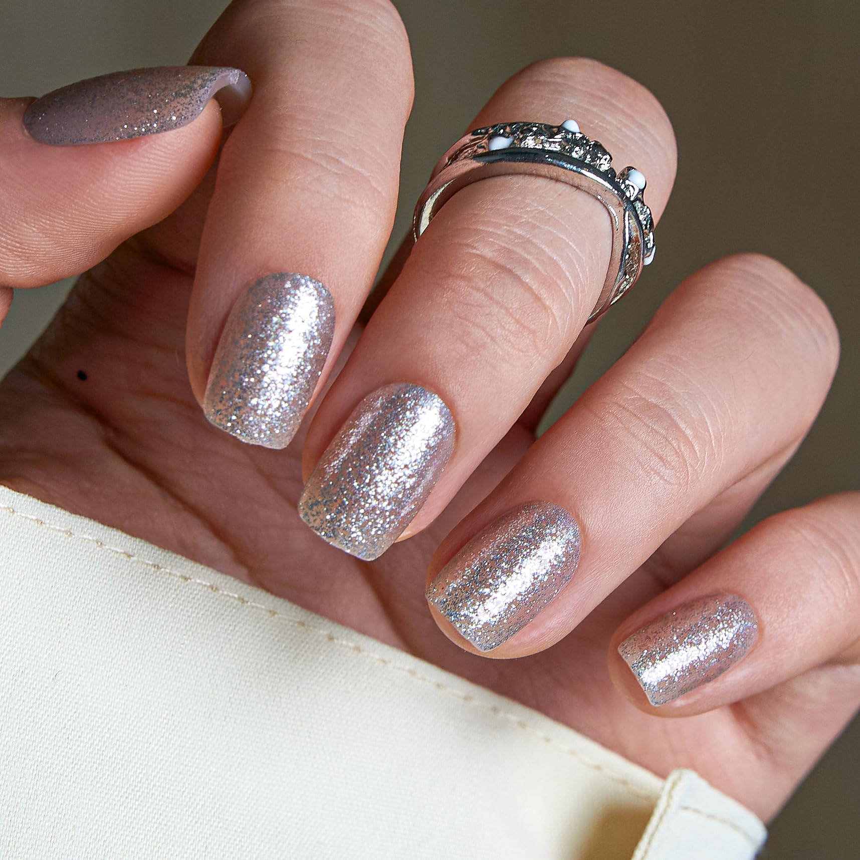 Curvlife front packaging showing short square silver glitter press-on nails and kit accessories for ready-to-wear convenience