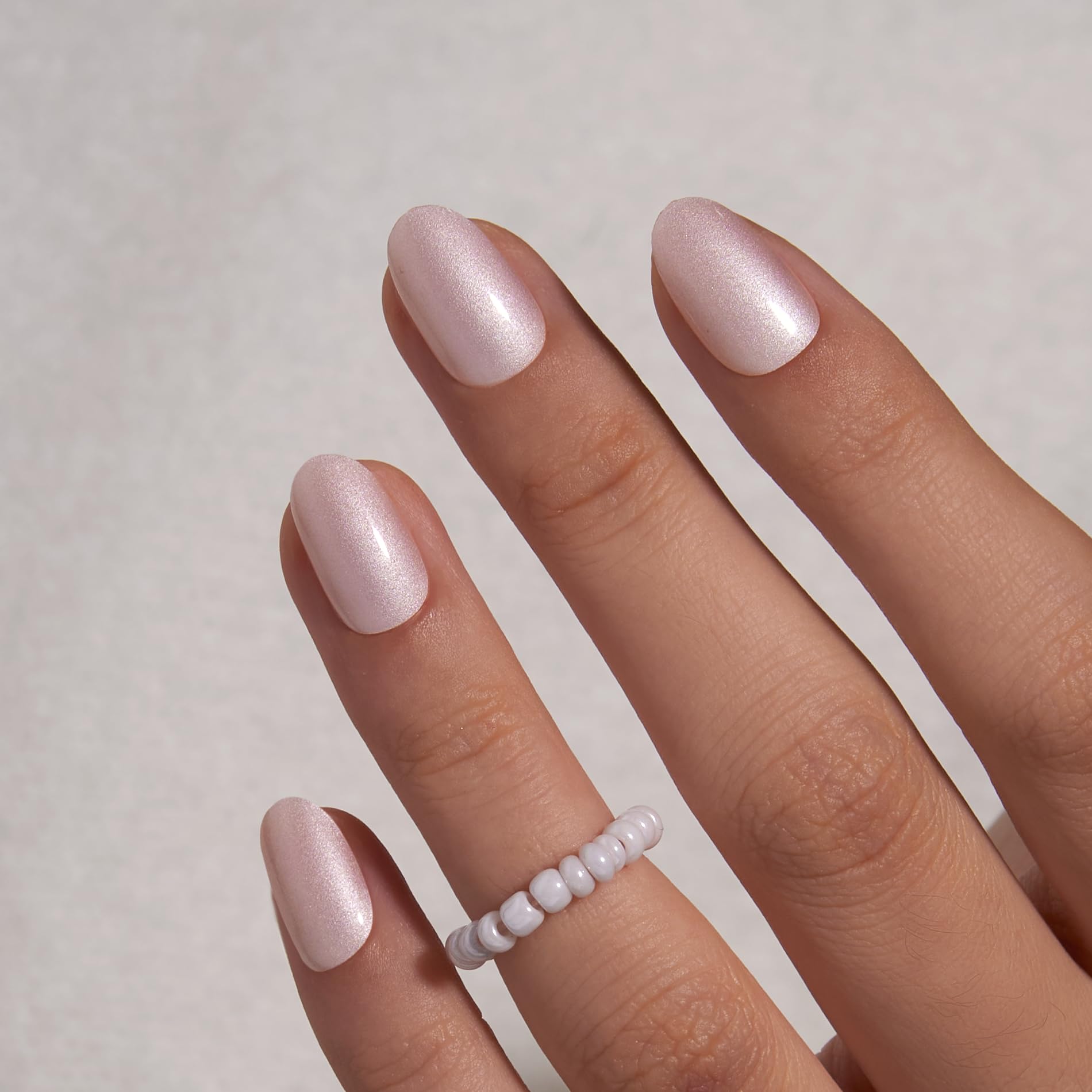 CurvLife nails on a hand typing at a desk demonstrating durability