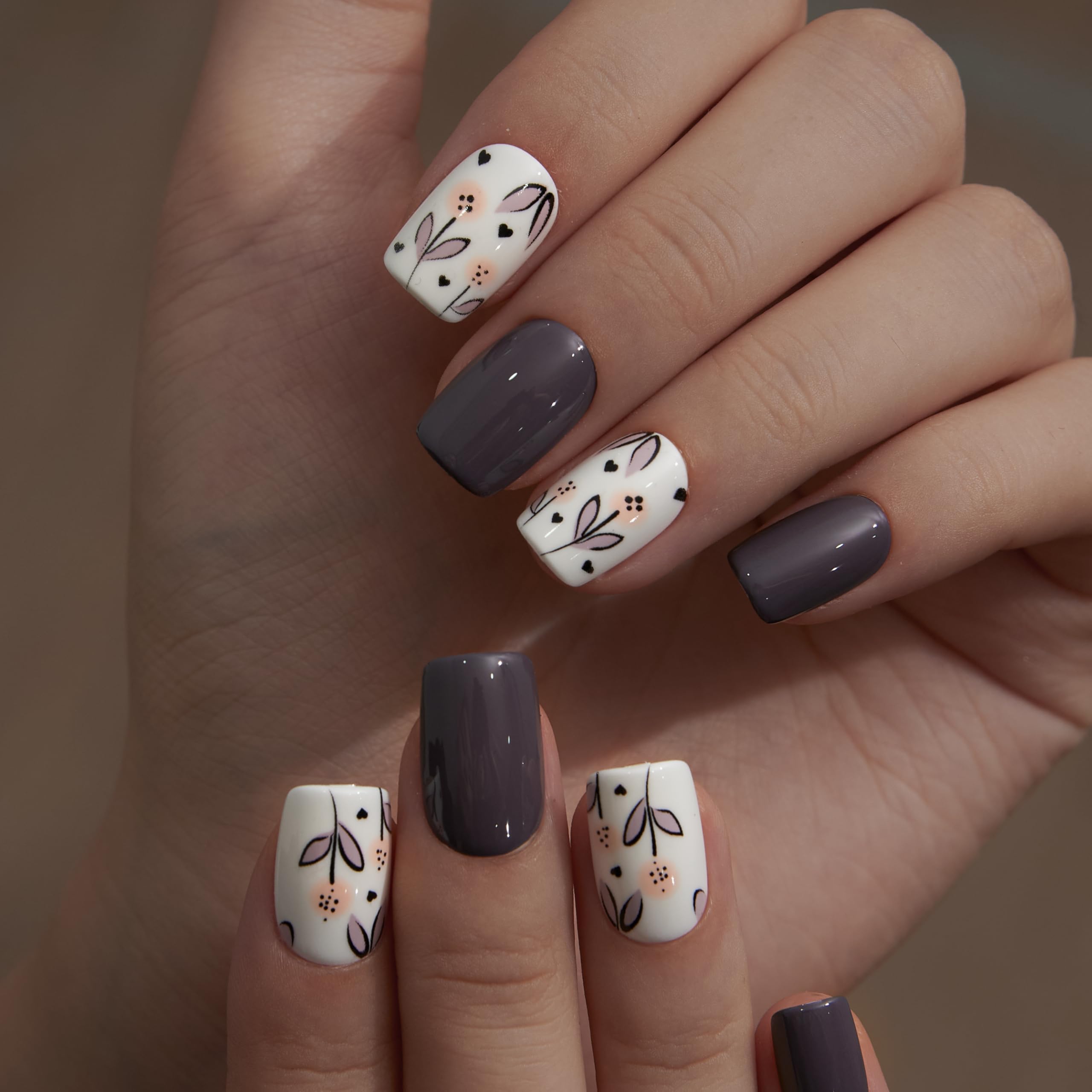 Curvlife hands wearing short square floral nails showing natural look