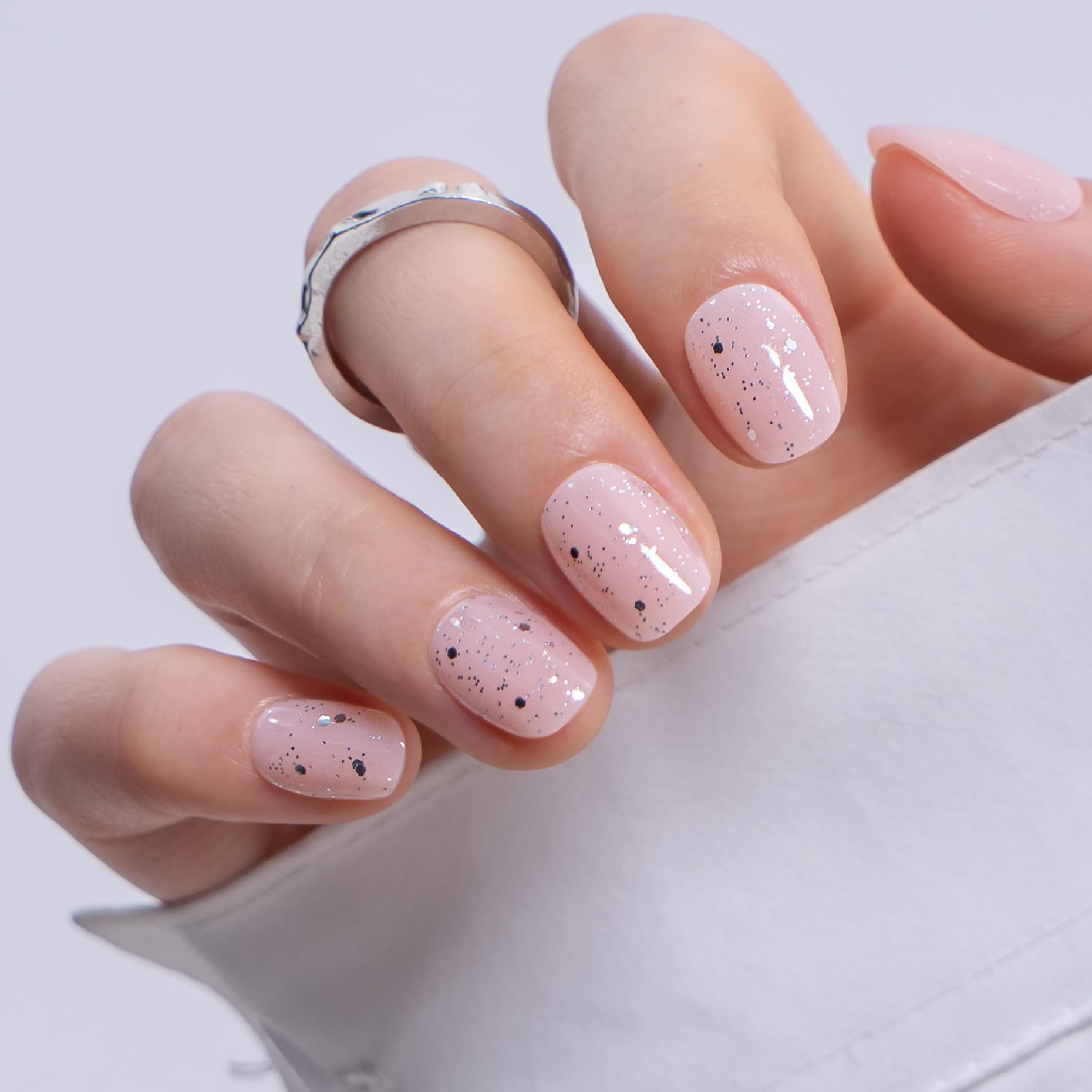 CurvLife nails in hand scale comparison illustrating extra short practicality