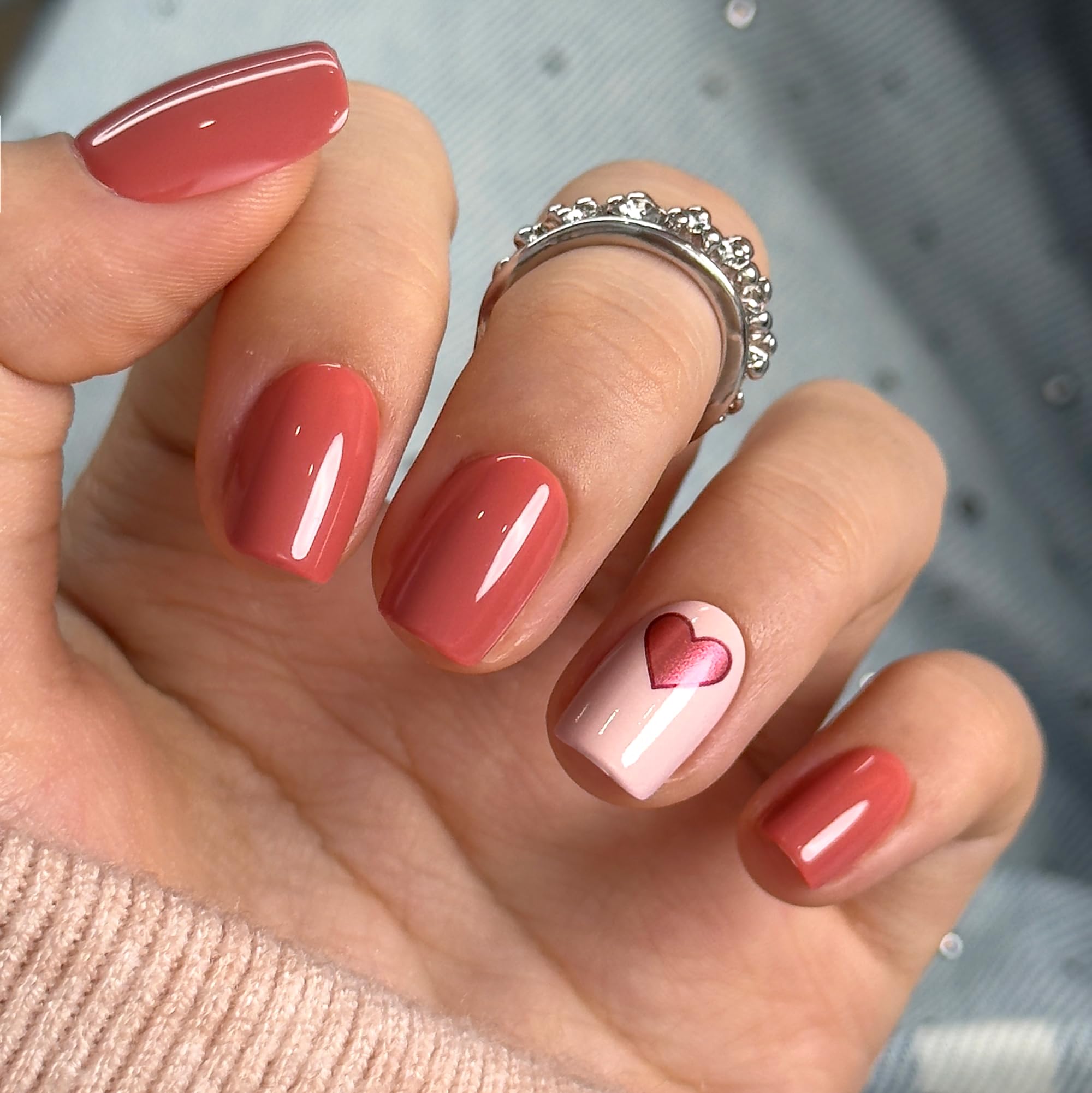 CurvLife nails in hand demonstrating short square size and natural fit benefit