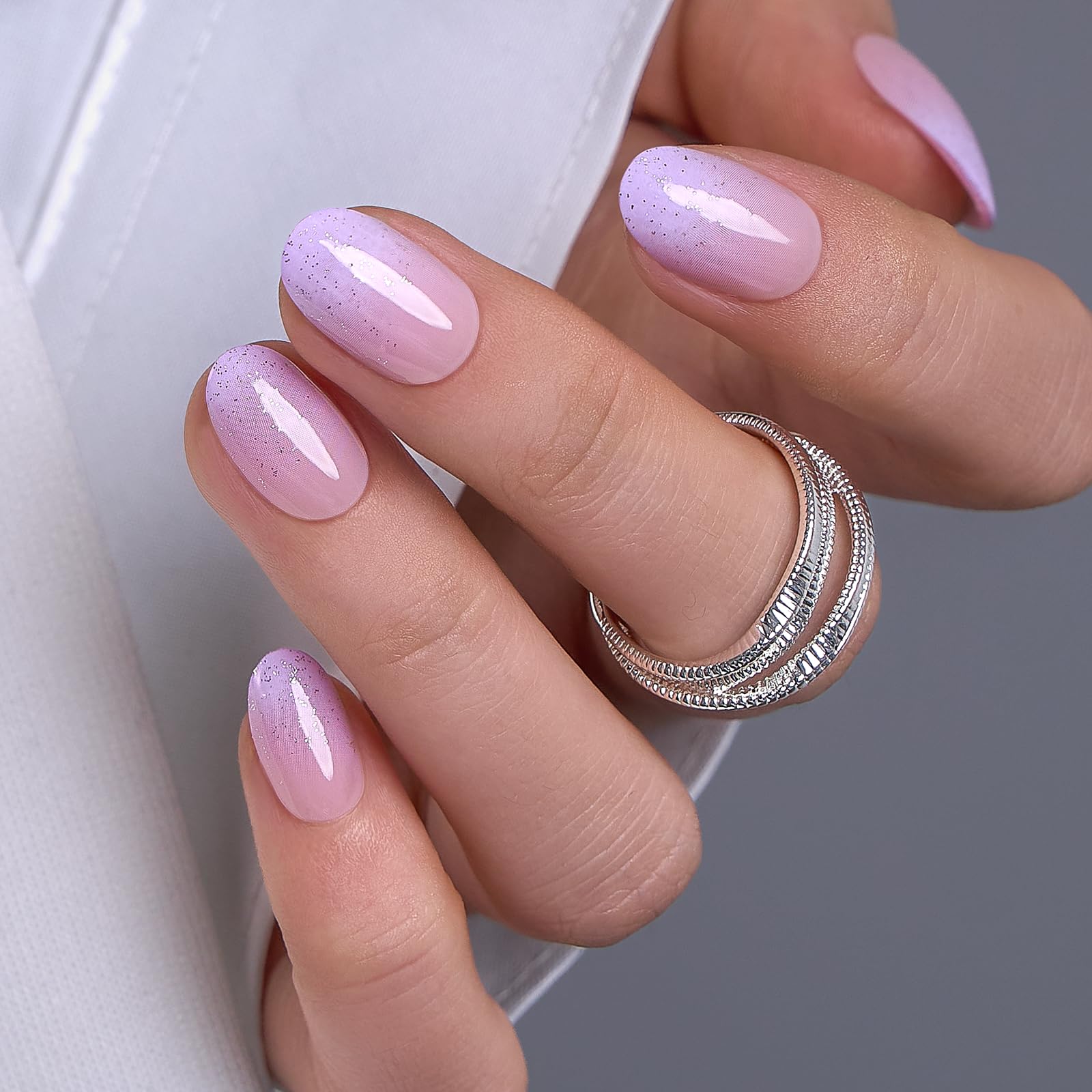 CurvLife press on nails in hand during application demonstrating quick glue or tab use