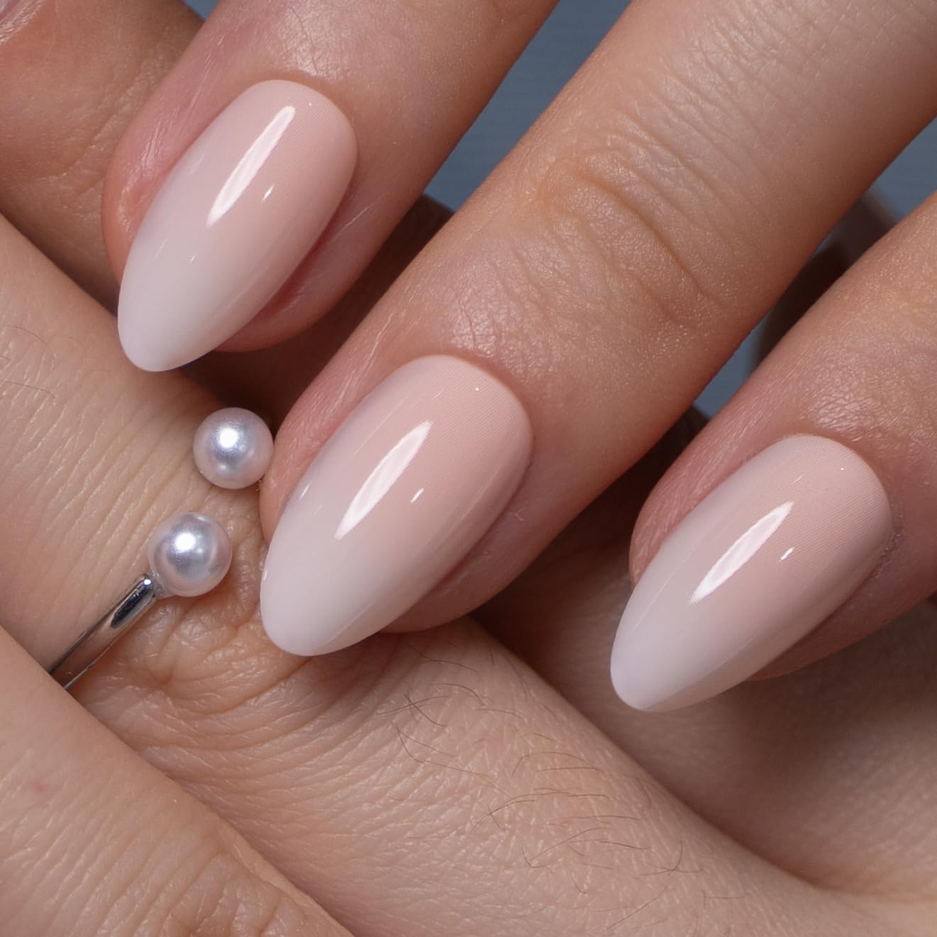 CurvLife single press-on nail on finger showing short almond scale and natural look benefit
