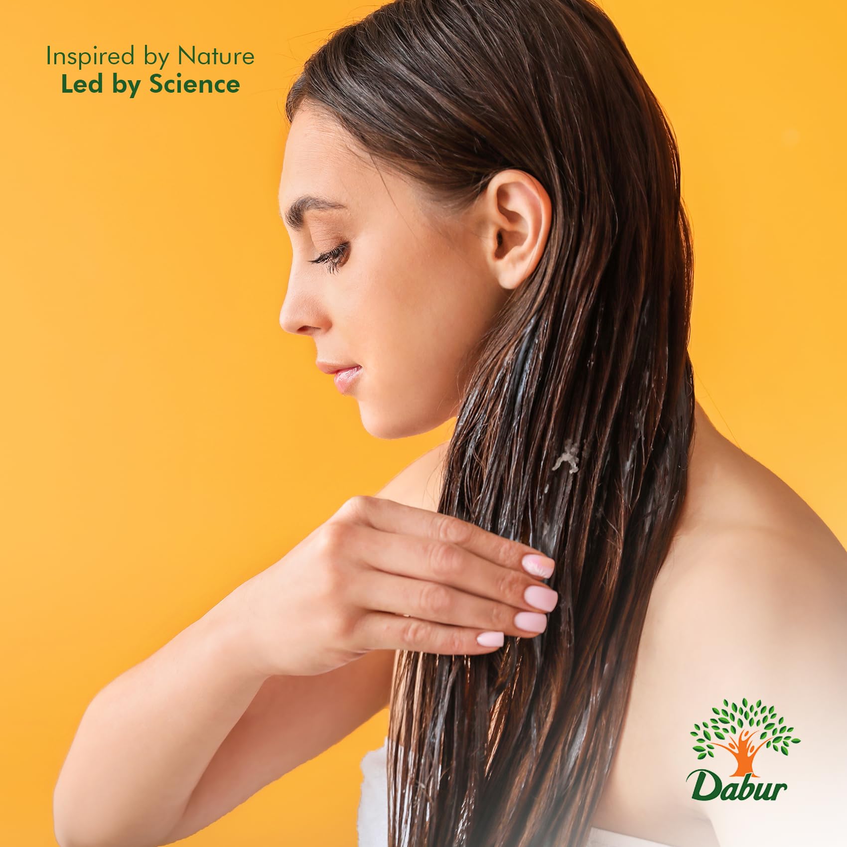 person massaging Dabur Maha Bhringraj oil into scalp demonstrating increased manageability