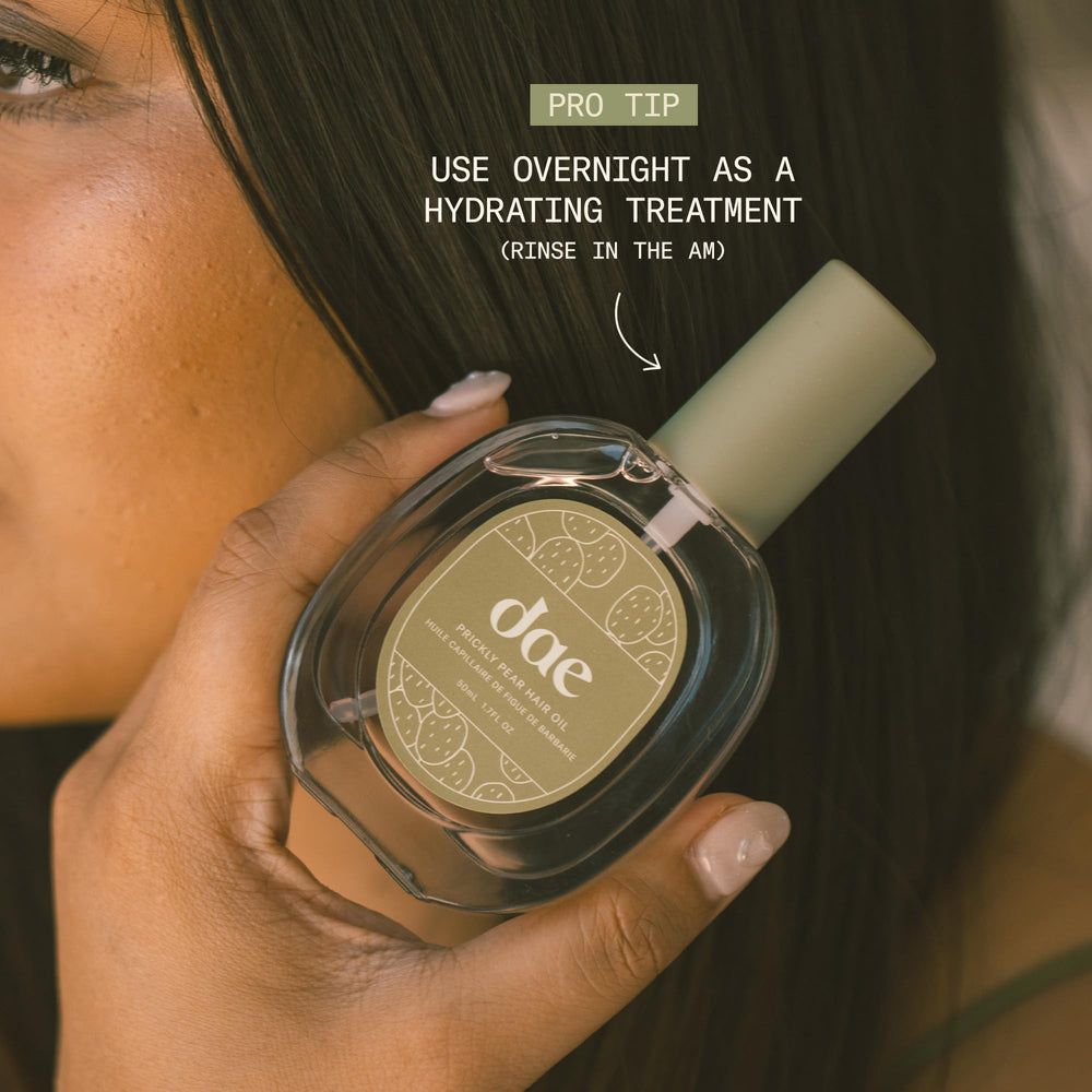 DAE bottle held in hand to show compact 1.7 oz travel-friendly size