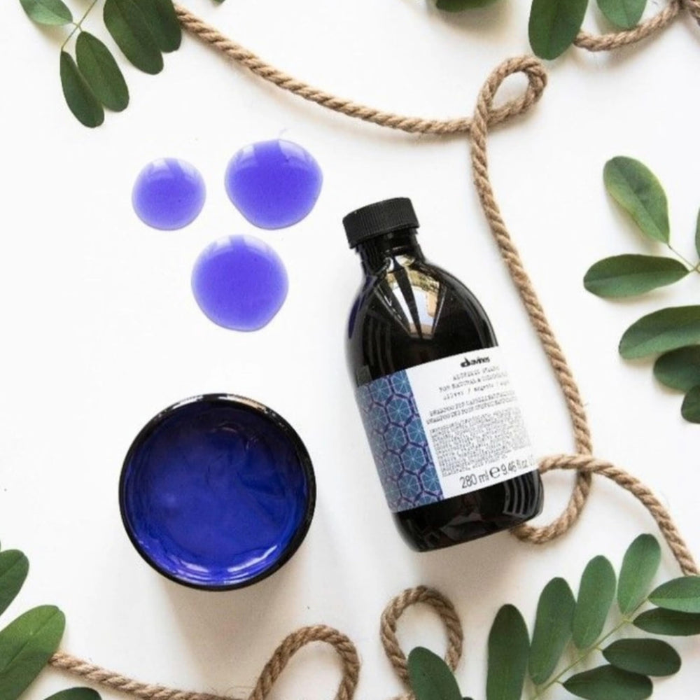 Davines 250ml bottle next to a hand for scale illustrating travel-friendly size