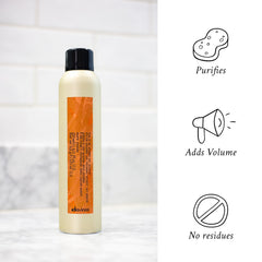Davines bottle in hand for size comparison and travel-ready benefit