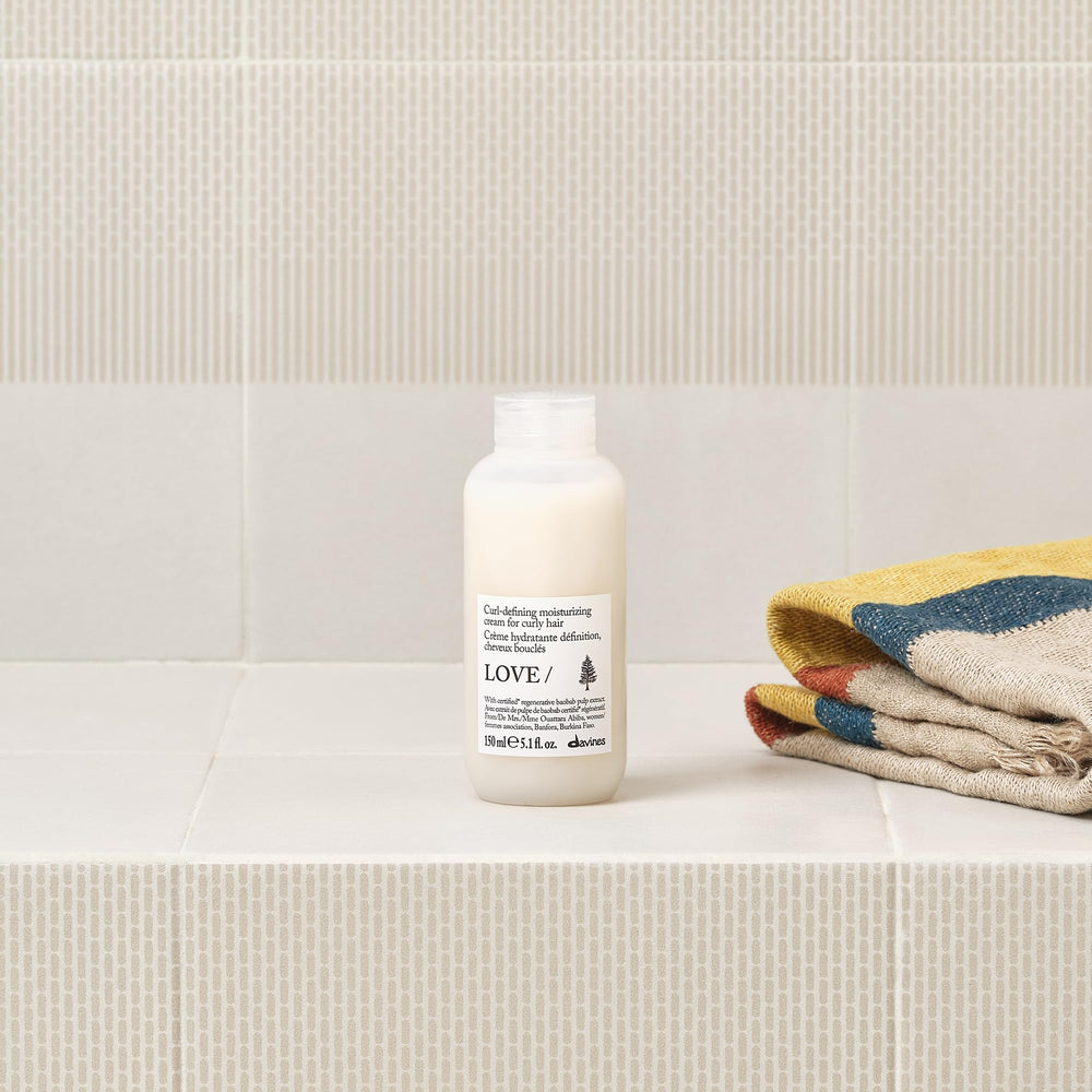 Davines LOVE CURL applied to wet hair showing curl formation and moisture