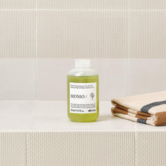 Davines MOMO/ being poured into a hand highlighting easy application