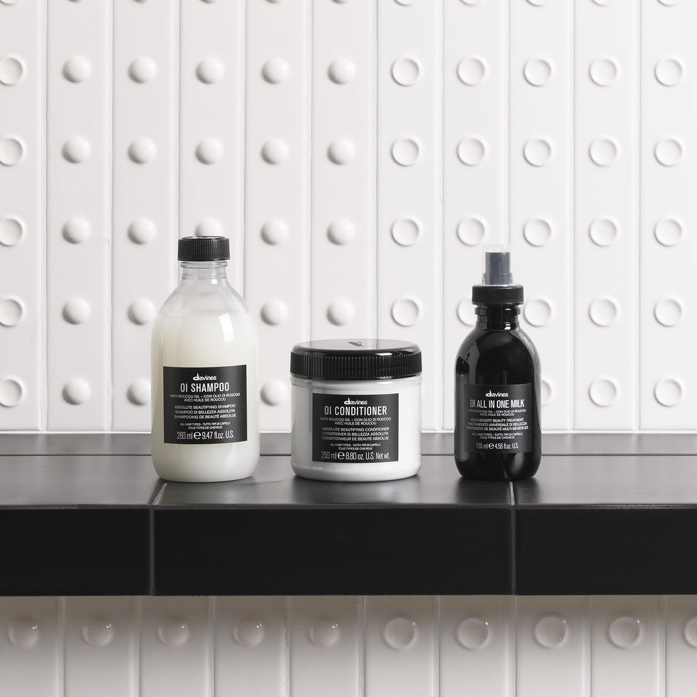 Davines OI Milk 4.56 fl oz next to 1.69 fl oz to show travel and full-size convenience