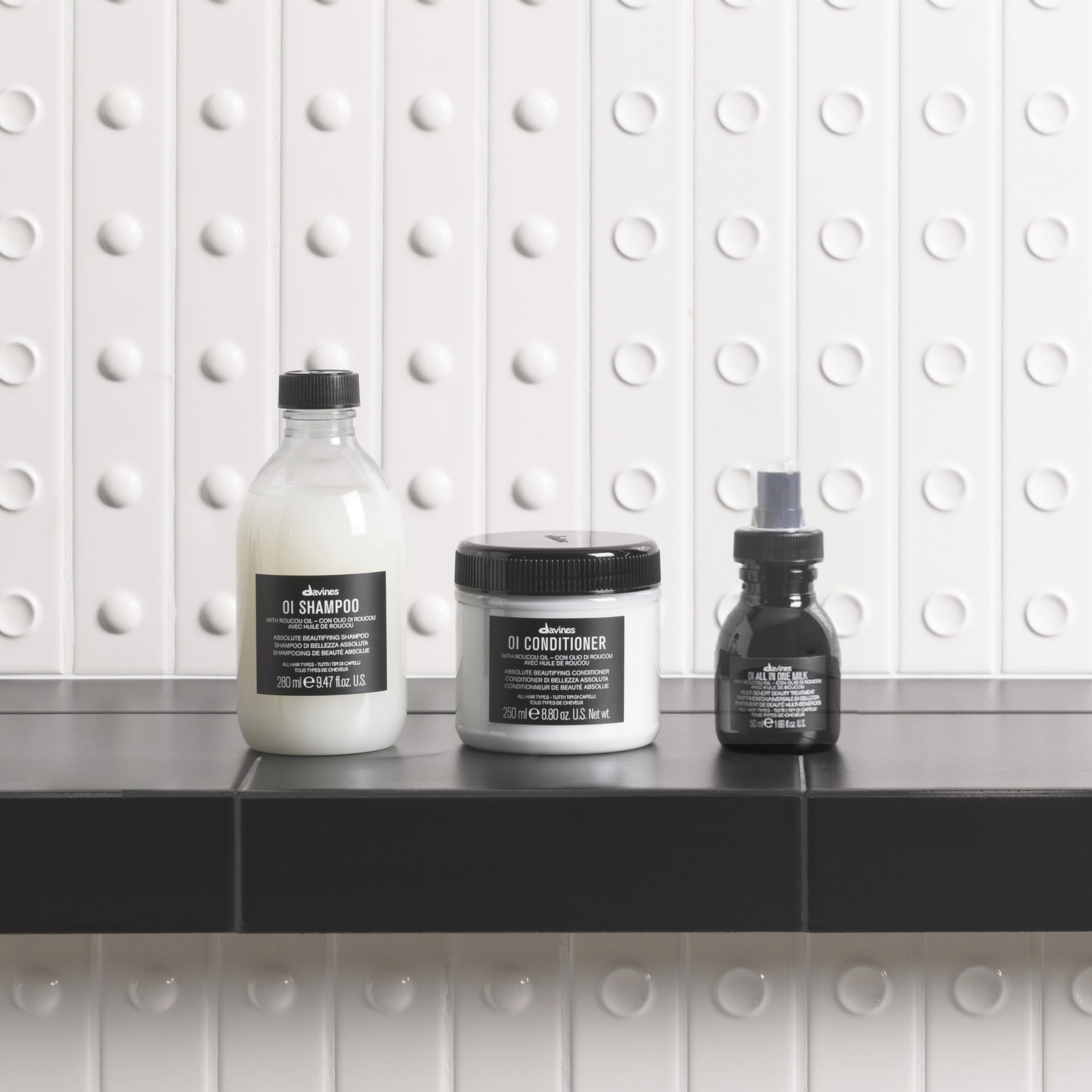 Pump dispensing Davines OI texture showing creamy formula for smoothing