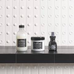 Pump dispensing Davines OI texture showing creamy formula for smoothing