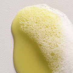 Davines bottle in hand showing 8.45 fl oz scale and travel-friendly benefit