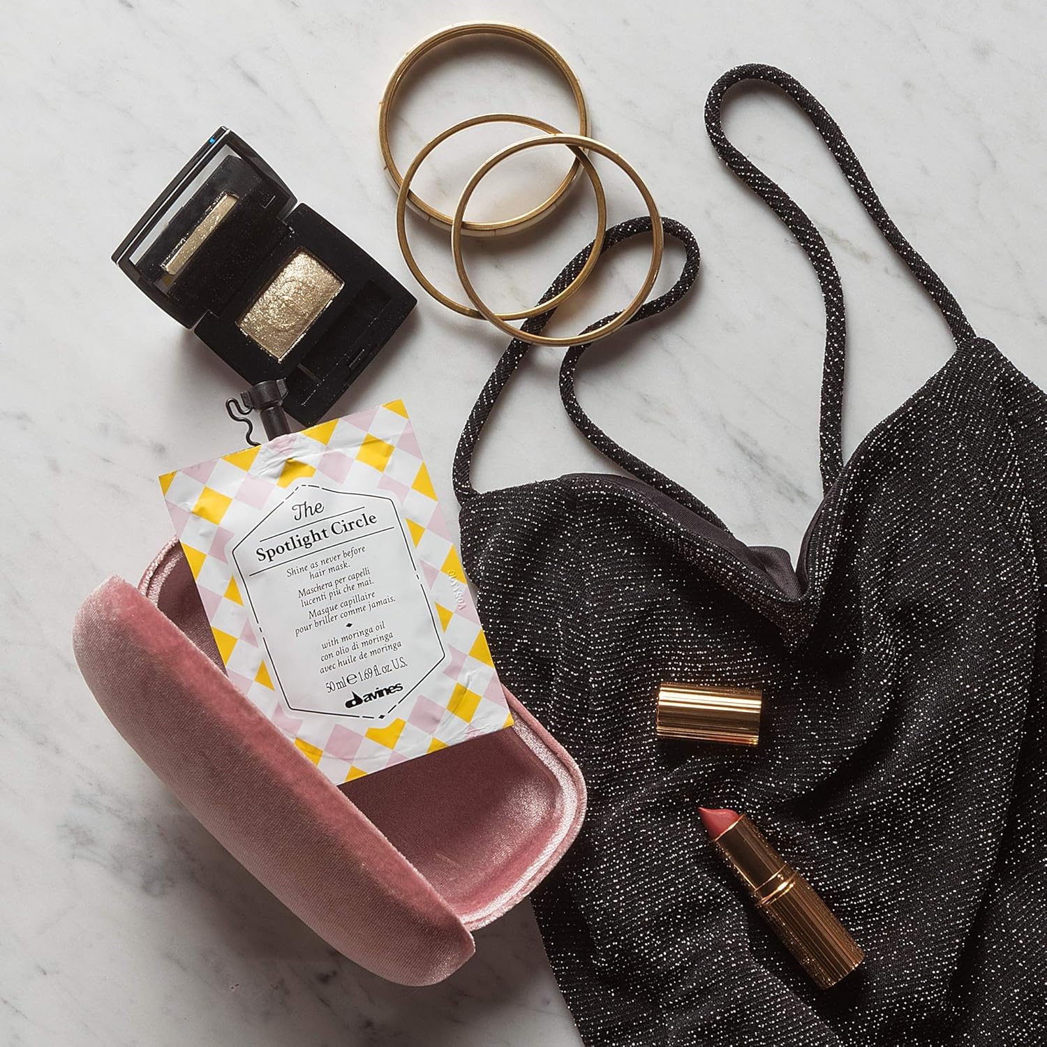 Davines mask size comparison next to hand demonstrating portable travel size