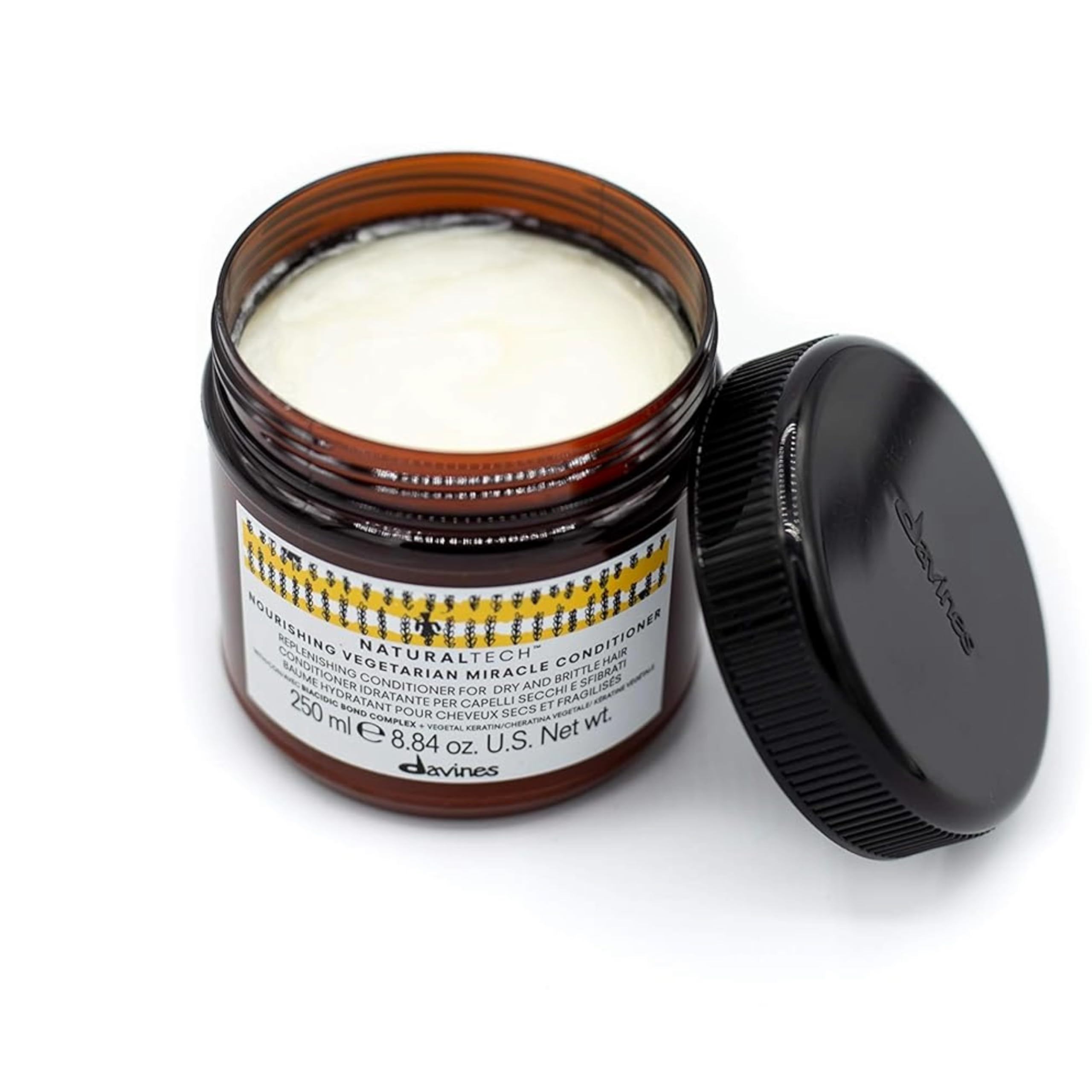Davines bottle held in hand to show 8.45 fl oz size