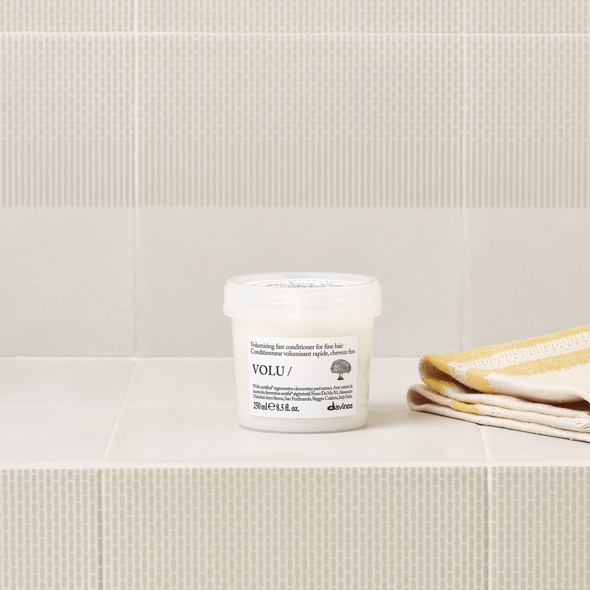 Davines conditioner texture on hand showing creamy lightweight consistency benefits