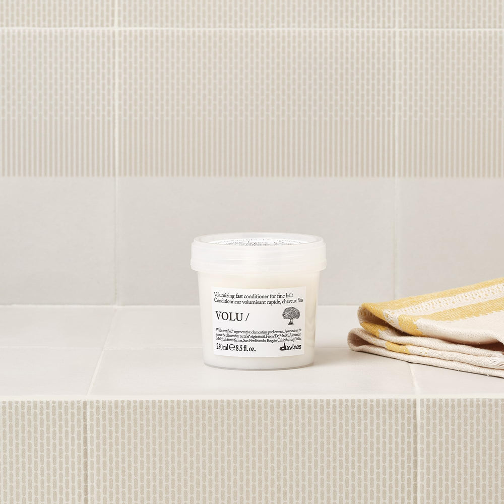 Davines conditioner texture on hand showing creamy lightweight consistency benefits