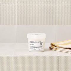 Davines conditioner texture on hand showing creamy lightweight consistency benefits