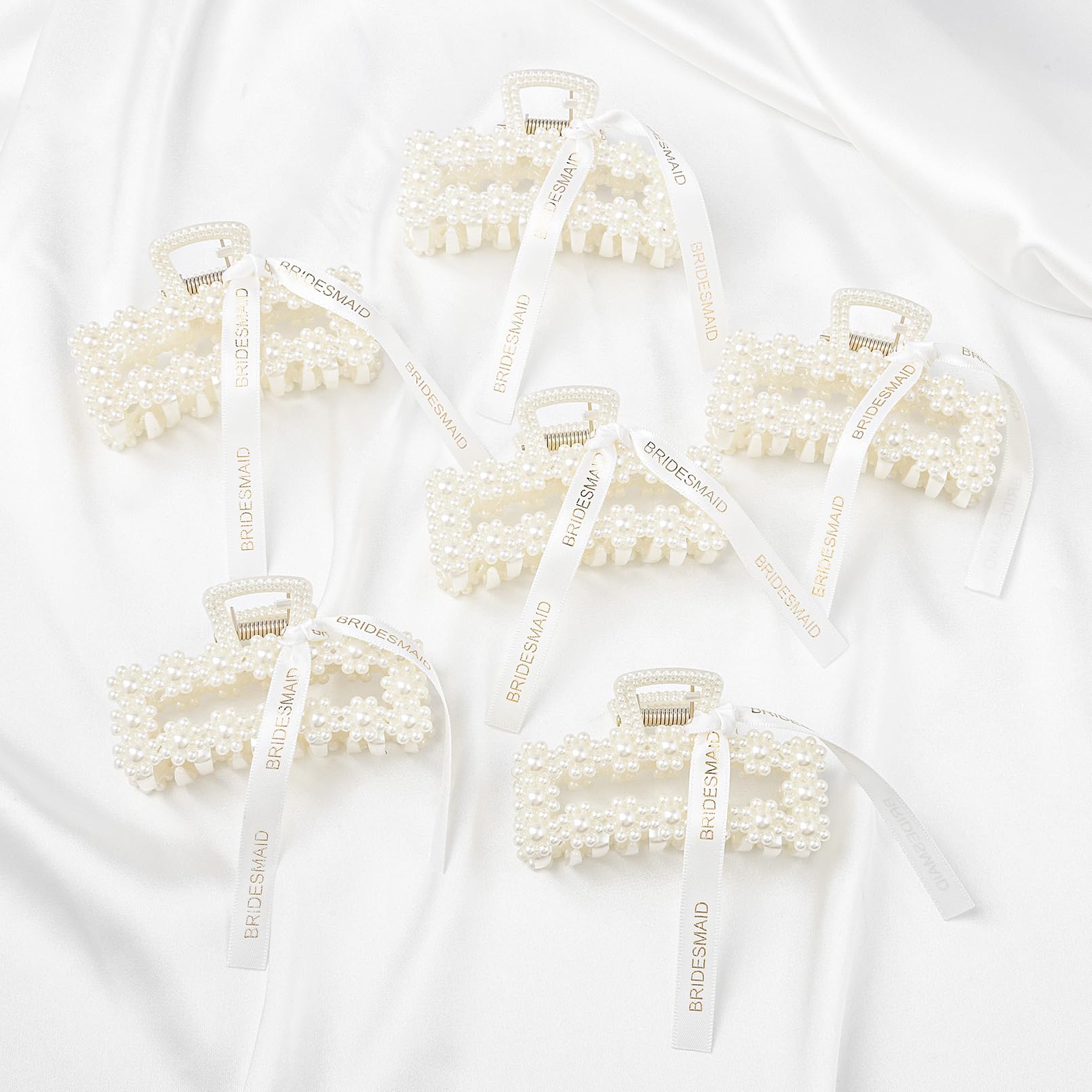 DEEKA clips held in hand to show true scale and practical gift size