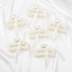 DEEKA clips held in hand to show true scale and practical gift size