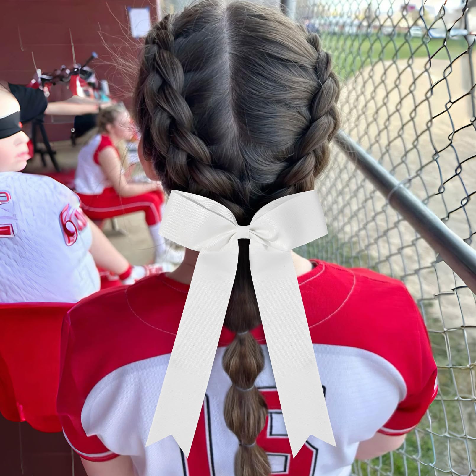 DEEKA group of girls wearing bows at game day illustrating team unity