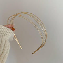 Deghew gold headband next to ruler and box showing size and easy storage for travel convenience
