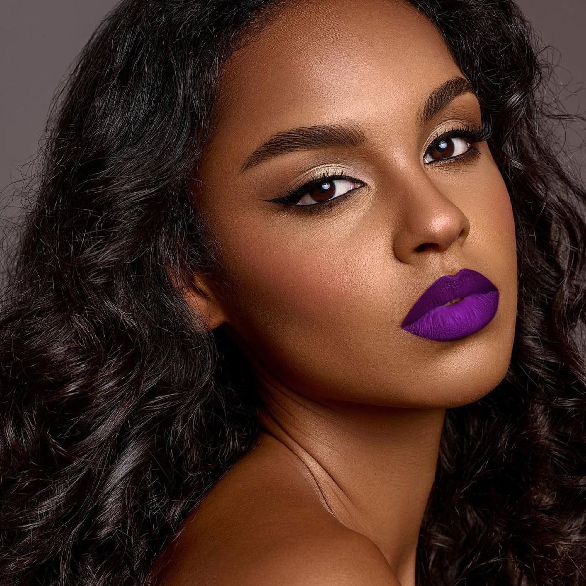 Depuplum DM22 rich lip swatch on skin illustrating true dark purple payoff