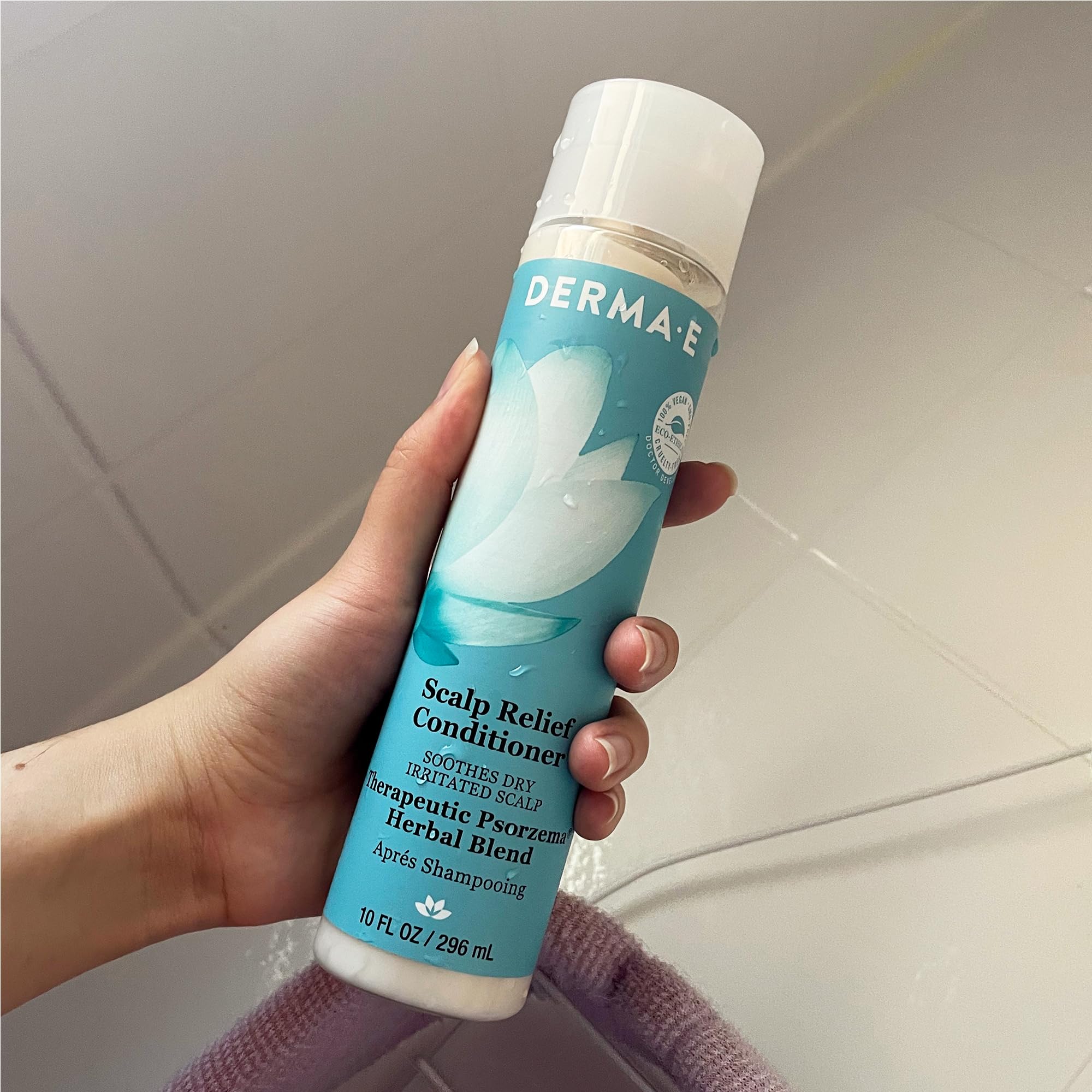 Derma E conditioner on bathroom shelf conveying daily hair and scalp care