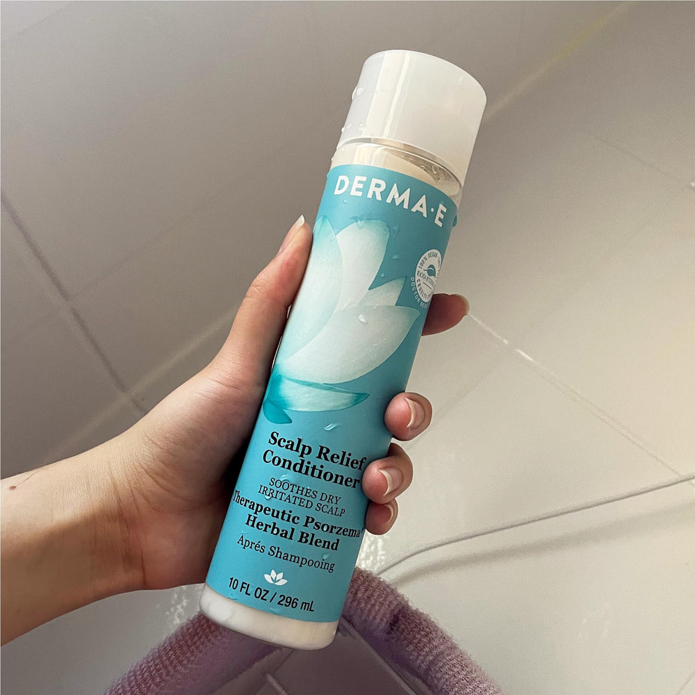 Derma E conditioner on bathroom shelf conveying daily hair and scalp care