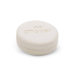 Dermaharmony bar in hand demonstrating compact 4 oz size and travel convenience