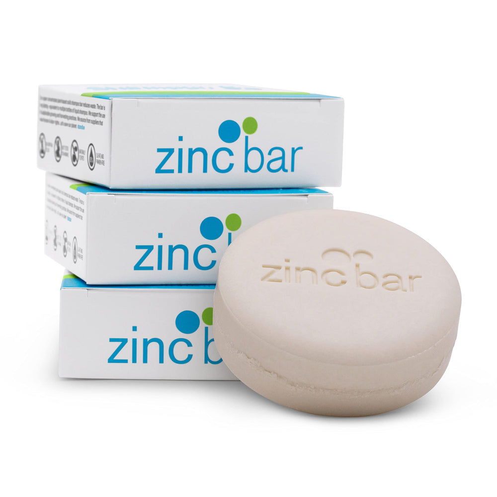 Dermaharmony shampoo bar on bathroom shelf illustrating travel convenience