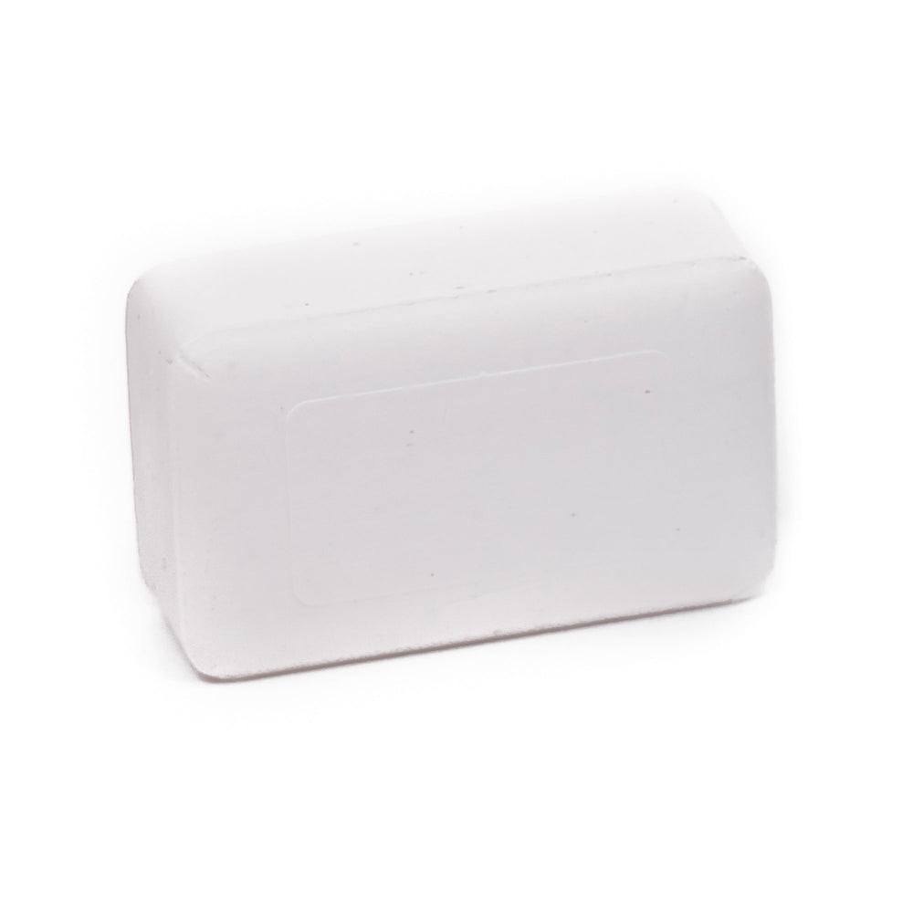 Dermaharmony soap held in hand showing 4 oz scale for travel convenience