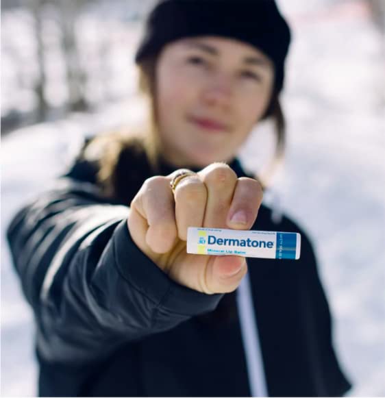 DERMATONE lip balm stick extended from cap showing ready-to-apply benefit